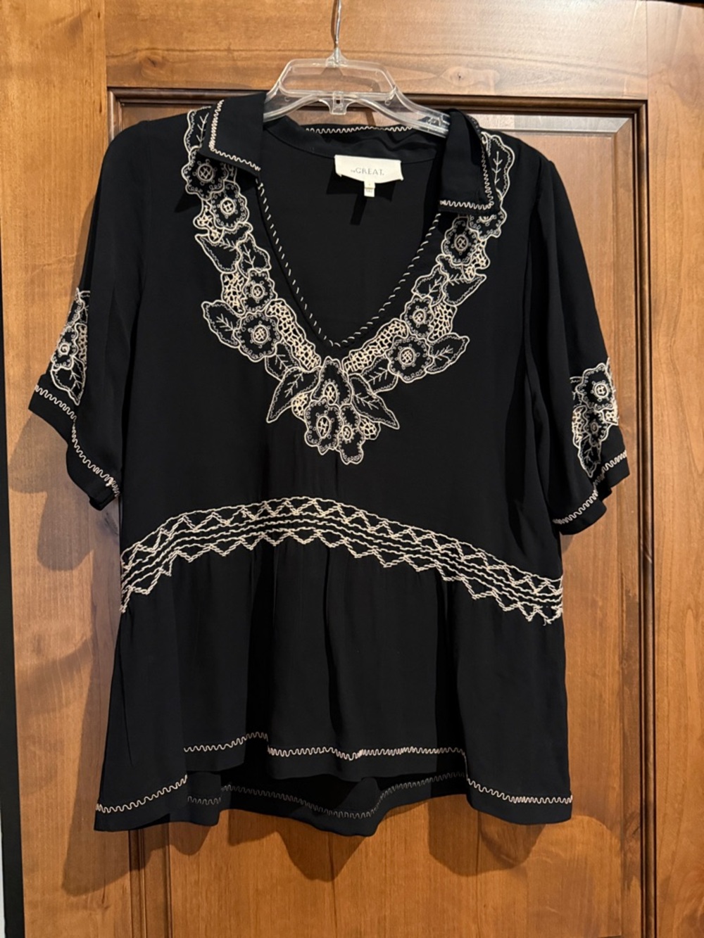 THE GREAT. Black Short-Sleeve V-Neck Tunic with White Floral Embroidery